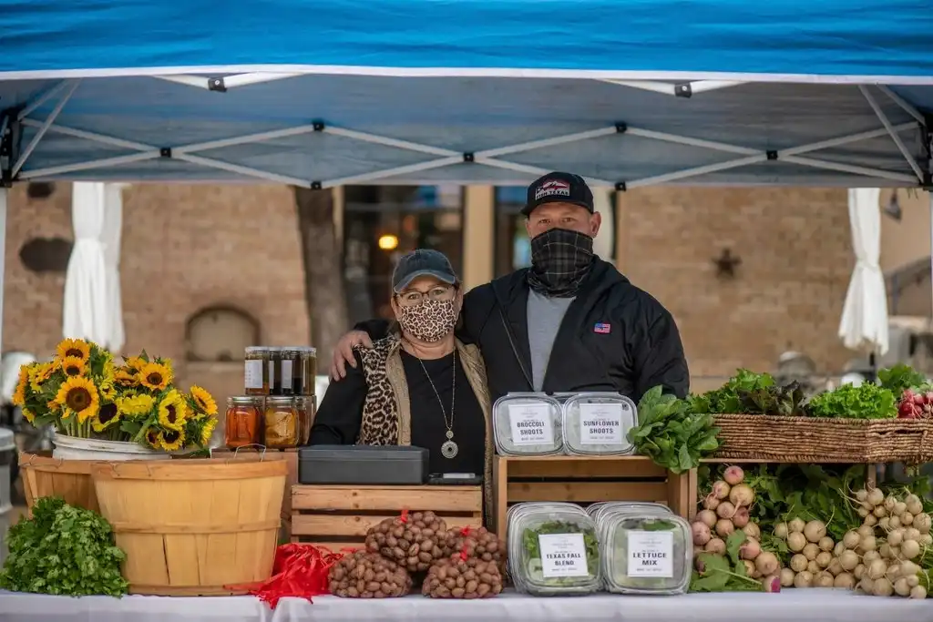Local business owners at a market stand