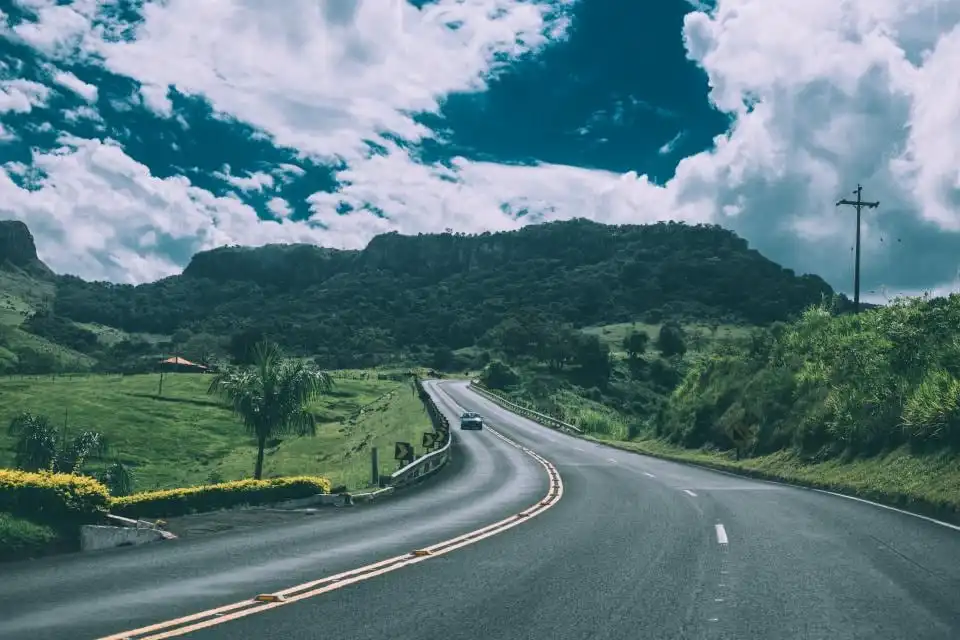 Winding road through green hills